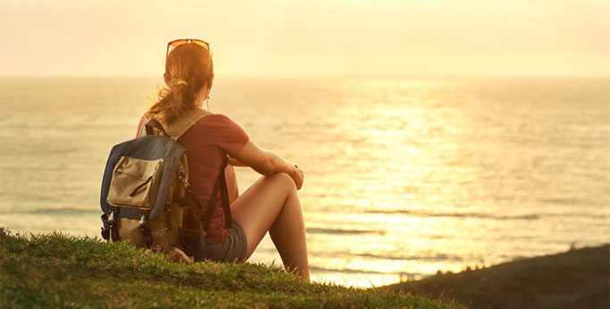 girl-backpack-enjoying-sunset-li